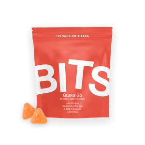 Bits Guava Go lozenges are depicted in this image. Two triangle-shaped edibles in orange color can be seen outside the package. The package itself is an orange-colored mylar bag with the word BITS in large letters across the front.