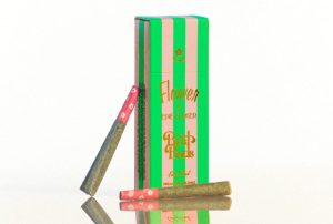 A green and light pink striped box of prerolls says "Flower by Edit Parker, Early Bird." Two joints can be seen.