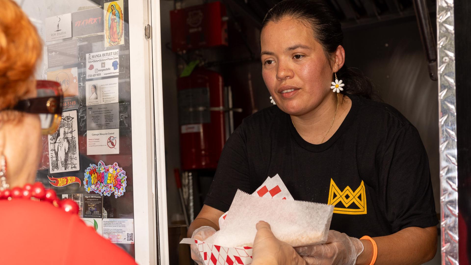 Queen City employee serving food to a customer.