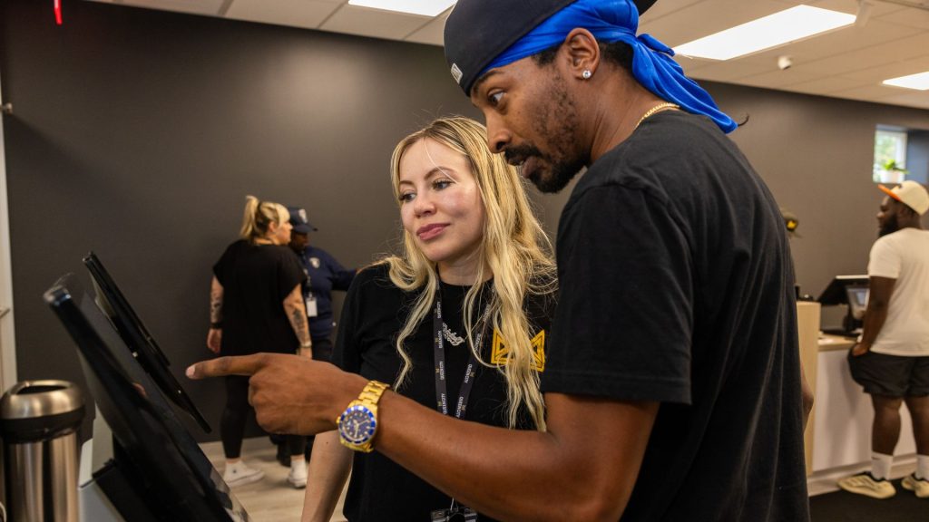 A customer orders cannabis from a kiosk at Queen City Dispensary.